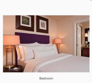 a bedroom with a large white bed with two lamps at Westin St. John in Cruz Bay