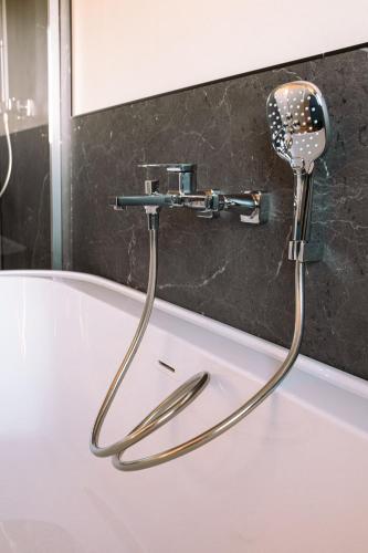 La salle de bains est pourvue d'un pommeau de douche mural. dans l'établissement ENTRE TERRE ET MER, à Desvres