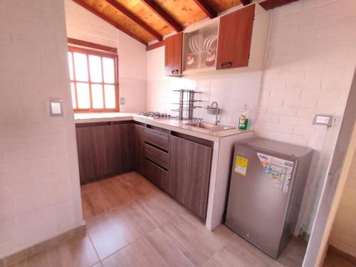 a kitchen with a sink and a refrigerator at Hermoso apartamento en Curití in Curití