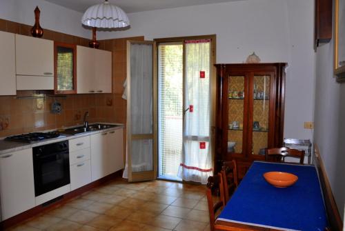 a kitchen with a table with a bowl on it at Appartamenti Pian d'Alma in Punta Ala