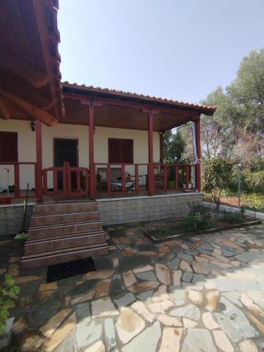 a house with a stone path in front of it at Stella's Apartment in Áyios Pávlos