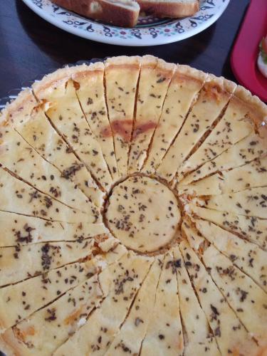 a close up of a cheese pizza on a table at Encanto da Praia hotel pousada in Natal