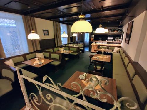 a restaurant with tables and chairs and lights at Gasthof Post in Frankenmarkt