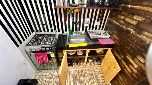a small kitchen with a sink and a stove at La Marteja in Salento