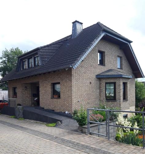 a brick house with a black roof at Kaisers Ferienhaus in Kaifenheim