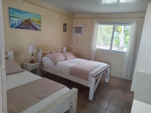 a bedroom with two beds and a window at Buccaneer Resort in Bocas Town