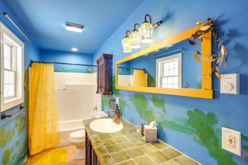 een blauwe badkamer met een wastafel en een toilet bij Colorful Milford Home on 7 Wooded Acres! in Milford