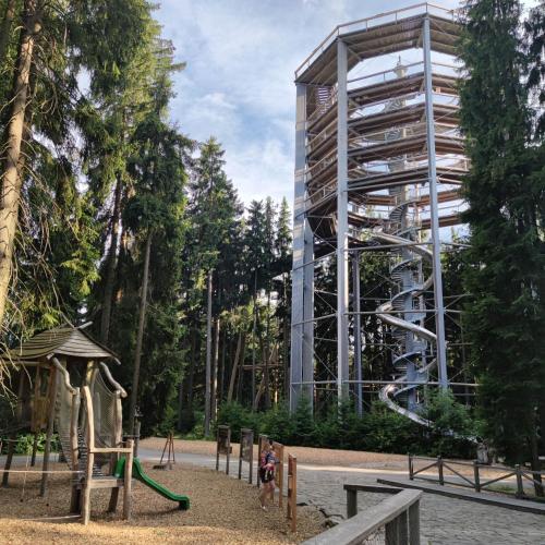 a playground in front of a building with a slide at U Macháčků - Lipno in Lipno nad Vltavou