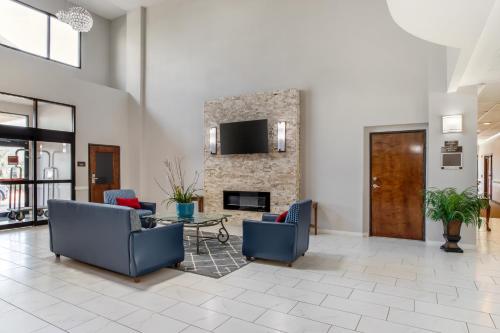 a lobby with two chairs and a fireplace at Comfort Suites Bush Intercontinental Airport in Houston