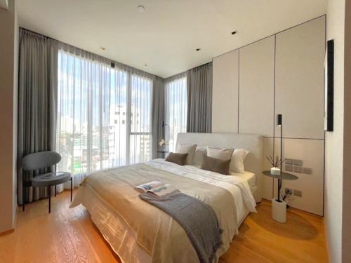 a bedroom with a large bed and a large window at Super Luxury Designer Sleeps 6 People in Thonglor in Bangkok
