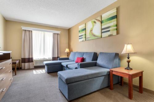 a living room with two blue couches and a tv at Comfort Suites Bush Intercontinental Airport in Houston