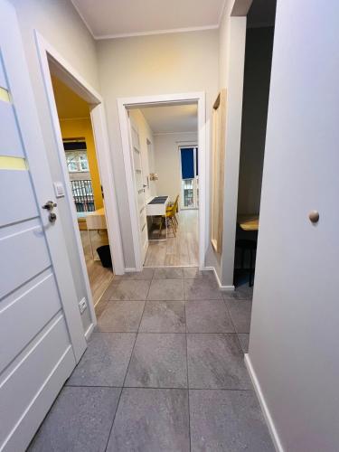 a hallway with a door leading to a dining room at Abra V Apartament in Poznań