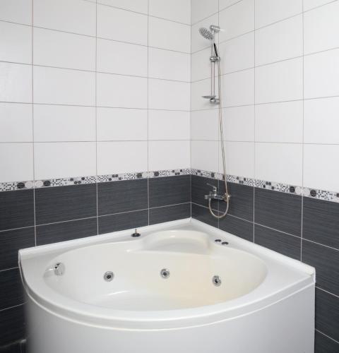 a bath tub in a bathroom with a shower at Villa Raya3 in Fethiye