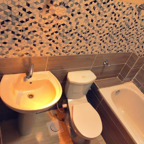 a bathroom with a toilet and a sink at Summer Land Hotel in Abu Simbel