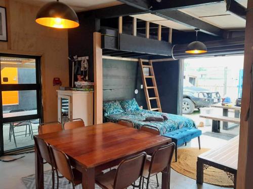 a dining room with a table and a bunk bed at Glamp Two-Five-Oh 