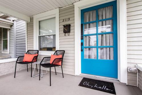a porch with three chairs and a blue door at 2BR Haven: Remodeled Gem! in Louisville