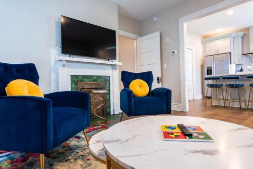 a living room with two blue chairs and a table at 2BR Haven: Remodeled Gem! in Louisville