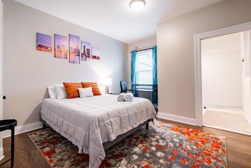 a bedroom with a bed and a large window at 2BR Haven: Remodeled Gem! in Louisville