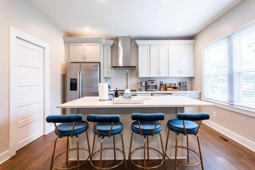 a kitchen with a island with four stools at 2BR Haven: Remodeled Gem! in Louisville