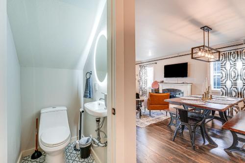 a bathroom with a toilet and a dining room at Historic Hollister Home Shop, Dine and Drink Nearby in Hollister