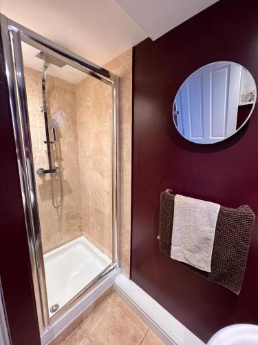 a bathroom with a shower and a glass shower stall at Cartref - Fully equipped and stunning town flat in Shrewsbury