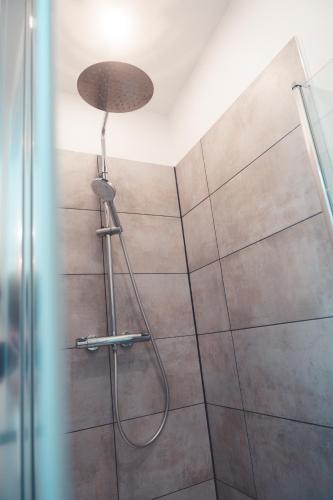 une douche avec pommeau de douche dans une salle de bain dans l'établissement Le Prévert, T3 en centre ville, à Tours