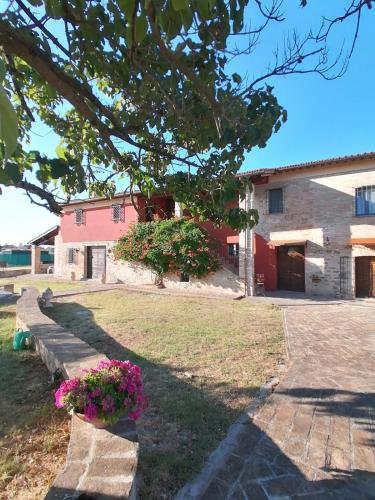 a house with a yard with flowers in front of it at CASALE ANTONELLA in Bastia Umbra