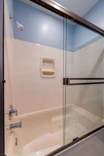 a shower with a glass door in a bathroom at Downtown Sophistication/ Two Bedroom / Two Bath in Louisville