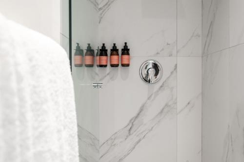 a bathroom with a shower with bottles of wine at Lumina at Noma Condesa Mexico City in Mexico City