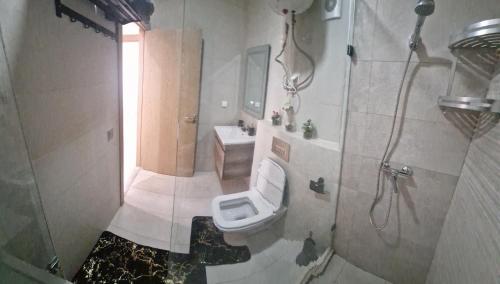 a bathroom with a toilet and a sink at Zenata ocean park appartement in Mohammedia