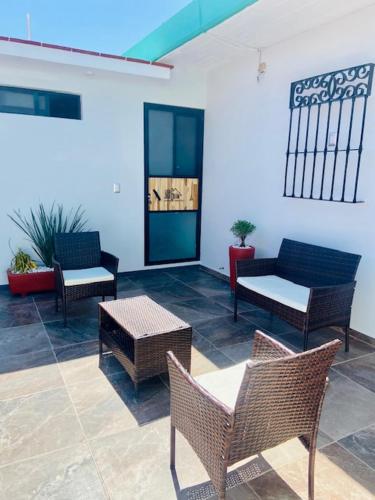 a lobby with chairs and tables and a couch at CASA JOAQUÍN HOSTAL in Oaxaca City