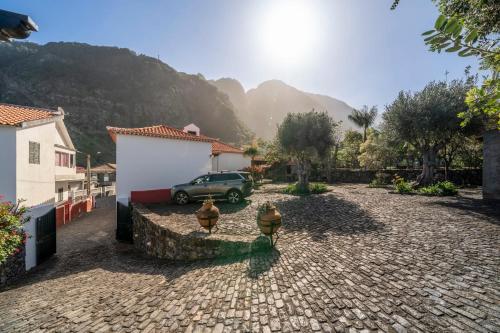 a car parked in a driveway with a stone road at Casa do Terreiro by An Island Apart in São Vicente