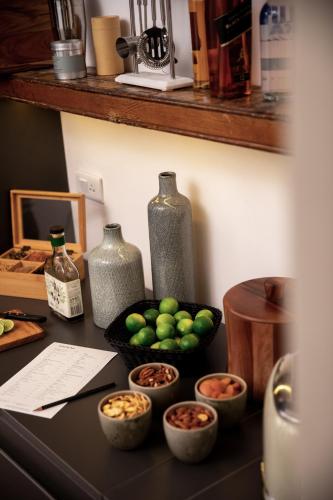a counter with vases and bowls of fruit on it at Fausto by Andean in Lima