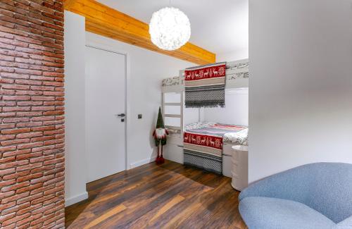 a bedroom with a brick wall and a bed in a room at Gudauri Mountain Views in Gudauri