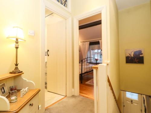 a bathroom with a sink and a door to a hallway at Charlottes Cottage in Windermere