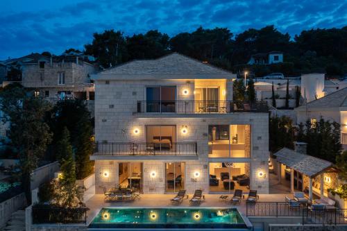 an aerial view of a house with a pool at night at Villa Stara in Selca
