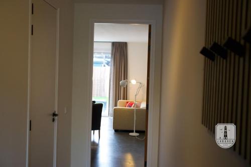 a hallway with a living room with a couch at InBuren in Buren