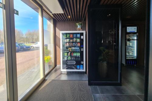 a drink cooler in a building with a window at Hotel Fogo Amsterdam in Amsterdam