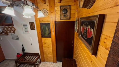 a hallway with a wooden door and a bench at Kagiabis' Nest in Gouves