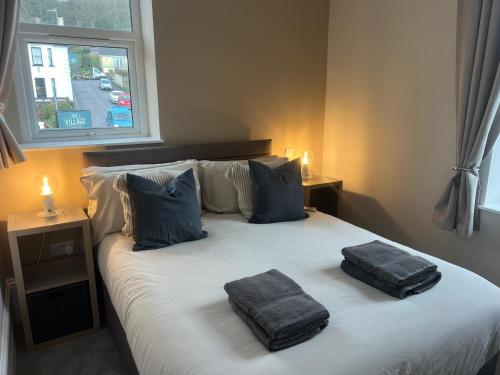 En eller flere senge i et værelse på North Coast Boutique Apartment