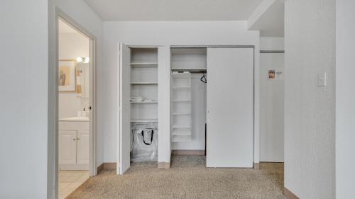 a walk in closet with white cabinets and a mirror at City Chic In A Modern Studio Haven! Pp in Harrisburg