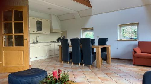 a kitchen and dining room with a table and chairs at Vakantiehuis De Fiere - wijngaard Zutphen in Zutphen