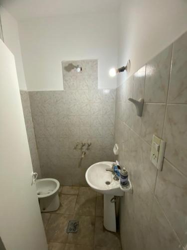 a bathroom with a sink and a toilet at Casa con cochera in Villa Krause