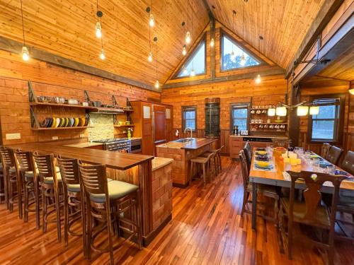 a large kitchen with wooden floors and wooden ceilings at Lake Tower Lodge in New Rome