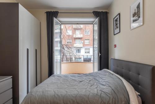 a bedroom with a bed and a window at Piazzale delle Provincie Apartment in Rome