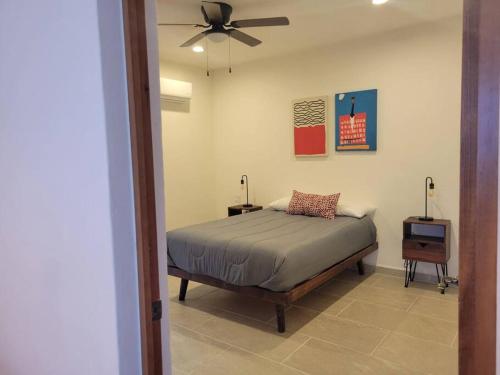 a bedroom with a bed and a ceiling fan at Cómodo departamento in Loreto