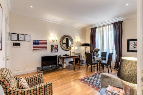 a living room with a couch and a dining room at Via Napoli Apartments in Rome