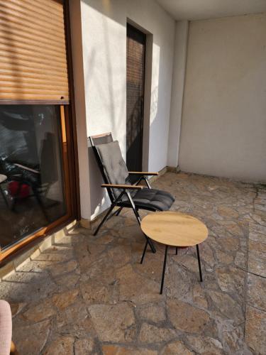 a chair and a table in a room with a fireplace at Happy place near Zvezdarska Forest in Zvezdara