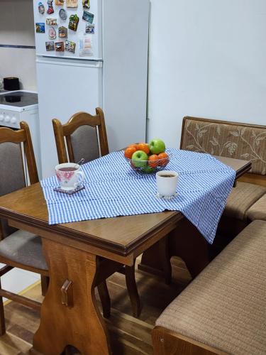 a table with a bowl of fruit on top of it at Happy place near Zvezdarska Forest in Zvezdara
