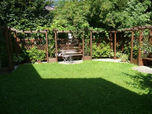 a garden with a bench in the middle of a yard at Landhaus Caesar - Hotel Garni in Bad Heilbrunn
